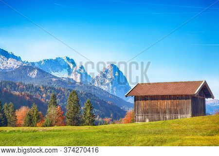 Splendid View Of Alpine Meadow Near Wagenbruchsee (geroldsee) Lake With Wooden Huts And Zugspitze Mo