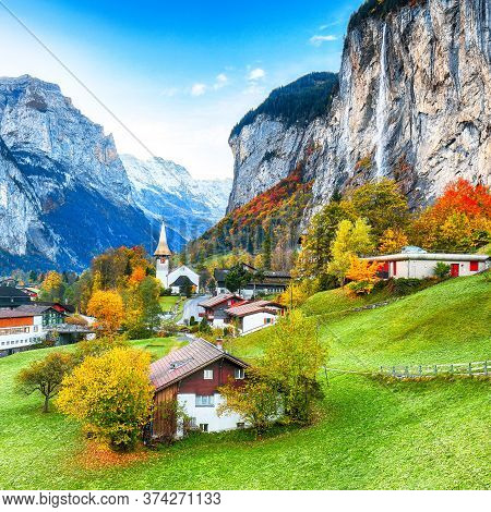 Gorgeous Autumn Landscape Of  Alpine Village Lauterbrunnen With Famous Church And Staubbach Waterfal