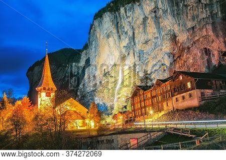 Captivating Autumn View Of Lauterbrunnen Church With Illuminated Staubbach Waterfall .  Location: La