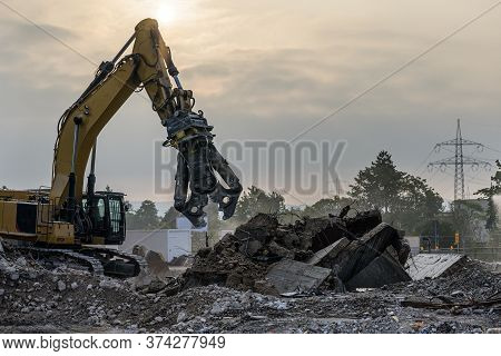 Building House Demolition Site Excavator With Hydraulic Crasher Machine And Yellow Container