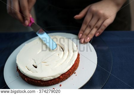 The Confectioner Levels The Cream On The Cake. The Cook Creates A Cake, Collects It And Covers It Wi