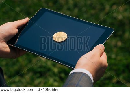 Top View Of Bitcon Cryptocurrency Lies On Digital Tablet. Virtual Money Or Coin Close Up Sign