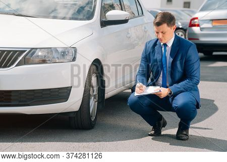 A Man Writes In A Tablet Next To The Car. An Accident On The Road, The Airbag Didnt Work.
