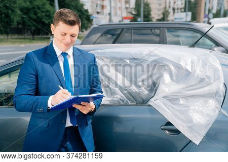 A Man Writes In A Tablet Next To The Car. An Accident On The Road, The Airbag Didnt Work.