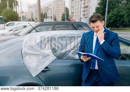 A Man Writes In A Tablet Next To The Car. An Accident On The Road, The Airbag Didnt Work.