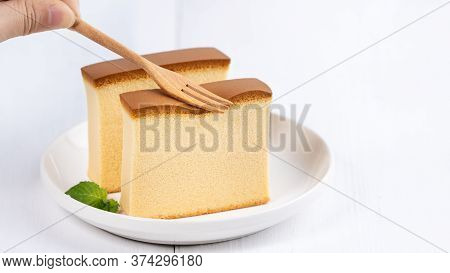Castella (kasutera) - Beautiful Delicious Japanese Sliced Sponge Cake Food On White Plate Over Rusti
