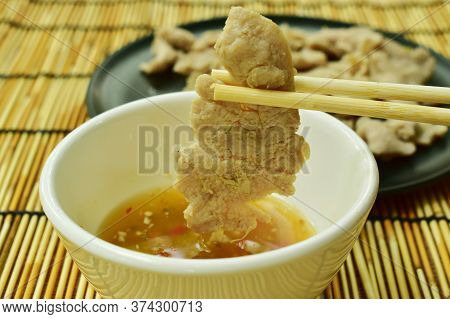 Boiled  Pork Slice Picking By Wooden Chopsticks Dipping Spicy Sauce