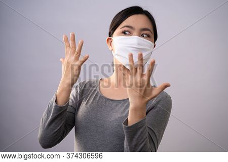 Don't Touch Your Face. Asian Woman Wearing Protective Face Mask Showing Hand Making Stop Sign Standi
