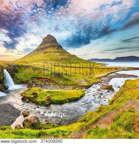 Dramatic View On Kirkjufellsfoss Waterfall  Near Kirkjufell Mountain At Sunset.  Location: Kirkjufel