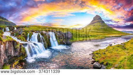 Dramatic View On Kirkjufellsfoss Waterfall  Near Kirkjufell Mountain At Sunset.  Location: Kirkjufel
