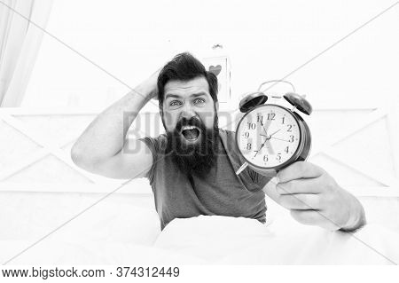 Get Up Right Now. What Time Is It. Stressed Man Alarm Clock. Sleepy Man Holding Alarm Clock In Bed. 