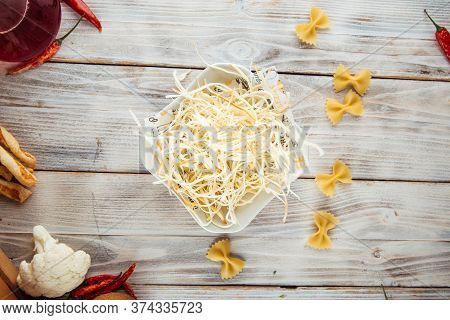 Top View On Fiber Smoked Cheese Chechil In A Bowl On The White Wooden Table, Horizontal