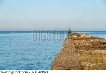 Poti, Georgia - 23, June 2020: Fisherman Fishes On The Black Sea, Poti