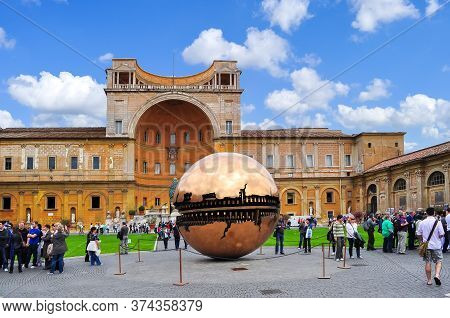 Golden Ball Sculpture And Belvedere Palace In Courtyard Of Vatican Museum, Vatican - May 2018