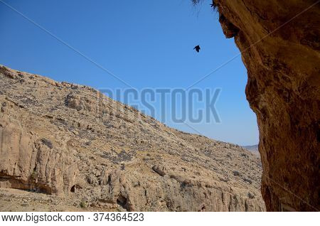Wadi Kelt Or Nahal Prat, In The Judean Desert, Israel. View Of The Cliffs And Blue Sky From The Cave