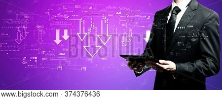 Descending Arrows With Businessman Using His Tablet Computer