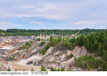 Multi-colored Clay Hills And Ravines On The Site Of An Old Kaolin Quarry, The Excavator Is Visible I