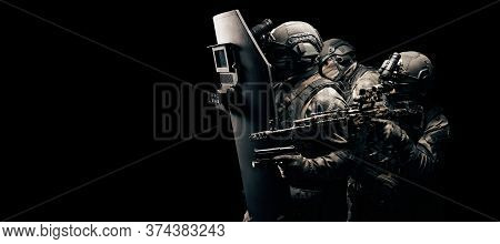 Portrait Of A Group Of Fighters Of A Special Unit. They Hide Behind A Bulletproof Shield. Black Back
