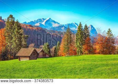 Splendid View Of Alpine Meadow Near Wagenbruchsee (geroldsee) Lake With Wooden Huts And Zugspitze Mo