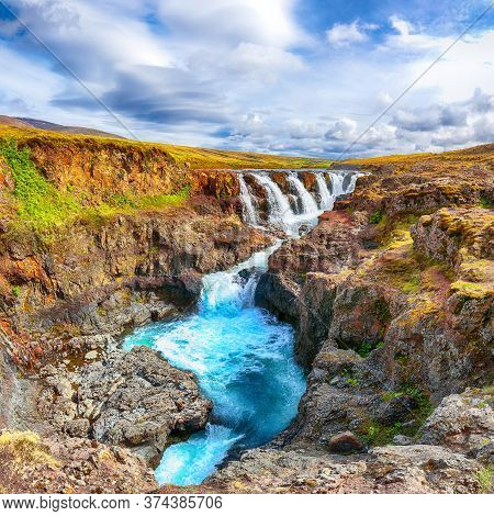 Captivating View Of  Kolufossar Waterfall At Summer Sunny Day.  Popular Tourist Travel Destination I