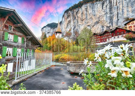 Stunning Autumn View Of Lauterbrunnen Village With Awesome Waterfall  Staubbach  And Swiss Alps In T