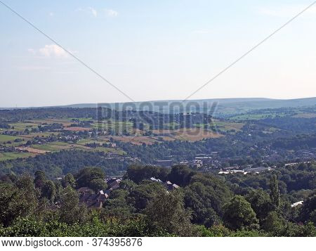A Panoramic View West Yorkshire Countryside With The Village Of Warley Surrounded By Woodland And Fa