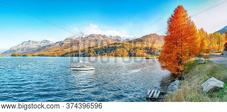 Picturesque Autumn Views Of Sils Lake (silsersee) With Small White Yacht. Colorful Autumn Scene Of S