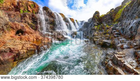 Captivating View Of  Kolufossar Waterfall At Summer Sunny Day.  Popular Tourist Travel Destination I