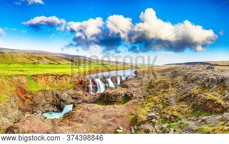 Captivating View Of  Kolufossar Waterfall At Summer Sunny Day.  Popular Tourist Travel Destination I
