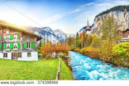 Stunning Autumn View Of Lauterbrunnen Village With Awesome Waterfall  Staubbach  And Swiss Alps In T