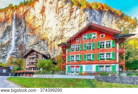 Fantastic Autumn View Of Lauterbrunnen Village With Awesome Waterfall  Staubbach  In The Background.