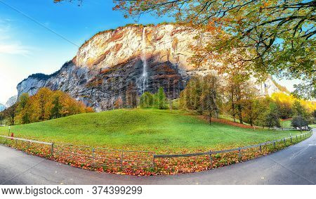 Fantastic Autumn View Of Lauterbrunnen Village With Awesome Waterfall  Staubbach  In The Background.