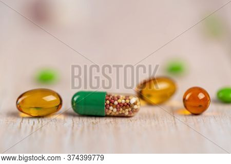 Home Therapy. Green Medicine Capsule Of Microgranules And Fish Oil Pills