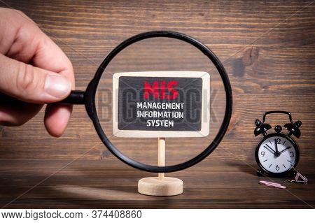 Mis, Management Information System Concept. Hand Holding Magnifying Glass