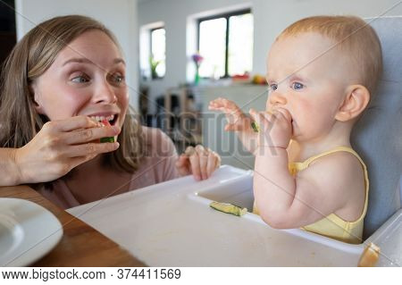 Happy Excited Mom Training Baby To Bite Solid Food, Eating Watermelon Together With Daughter. Closeu