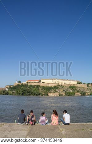 Novi Sad, Serbia - June 7, 2015: People Sitting Together In Front Of Petrovaradin Fortress In Novi S