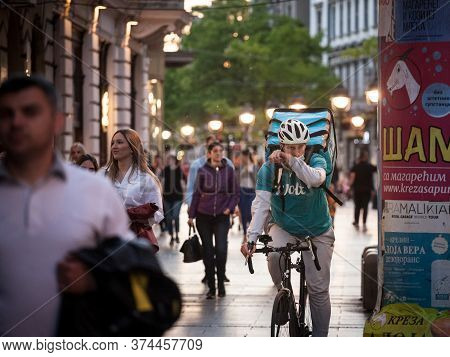 Belgrade, Serbia - May 8, 2020: Wolt Delivery Man Wearing A Face Mask Protective Respirator In Belgr