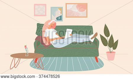 Freelance Concept.a Woman Sitting On Her Sofa And Works On A Laptop And Listens To Music On Headphon