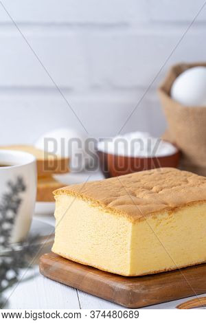 Plain Classic Taiwanese Traditional Sponge Cake (taiwanese Castella Kasutera) On A Wooden Tray Backg