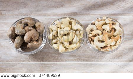 Natural And Roasted Cashew Nut On Wooden Background - Anacardium Occidentale