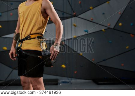 Cropped Shot Of Sportive Man, Rock Climber With A Bag Of Magnesia, Chalk. Training On The Artificial