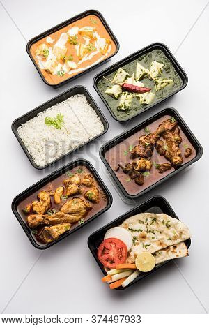 Online Food Delivery Concept For Indian Restaurant Showing Plastic Containers With Food