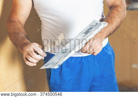 Hand With Putty Knife Repair Wall, Hand With A Spatula, Spatula With Spackle Paste Structure, Proces