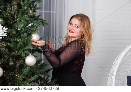 Nice Girl With Blond Hair, Blonde Decorates Christmas Tree, Getting Ready For The New Year Holiday