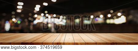 Panoramic Empty Clean Wood Counter Table Top On Blur Street Night Cafe Background Use For Pub Coffee