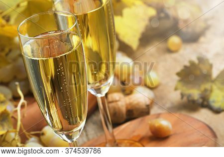 Champagne In Glasses, Grapes With Vine, Vintage Wood Background, Selective Focus