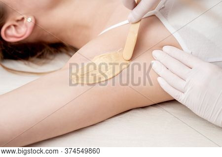 Depilation And Epilation Female Armpit With Liquid Sugar Paste By Spatula. Hand Of Cosmetologist App