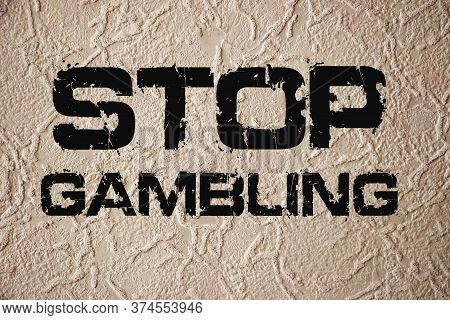 Stop Gambling Phrase Sign On Old Texturized Wall. Qut Addiction Concept On Grunge Background