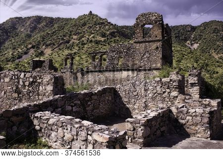 Rajasthan, India - October 06, 2012: A Landscape Of Hilly Mountains Surrounding Abandoned Cursed Rui