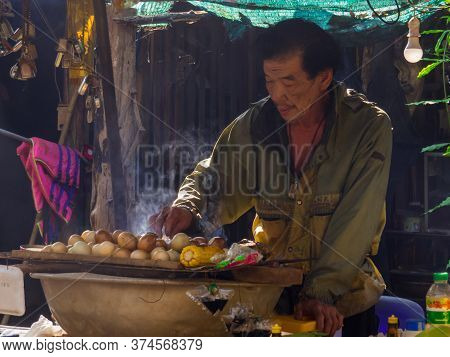 Thong Pha Phum, Thailand - January 4, 2020: Man Selling Traditional Food Near The Hin Dat Hot Spring